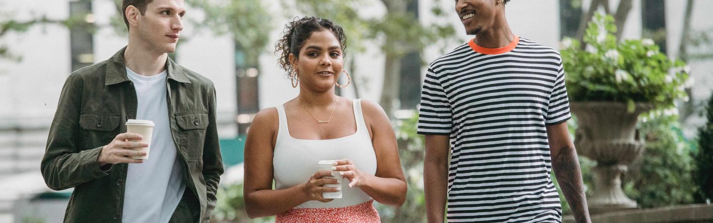 Three young people walking outside together